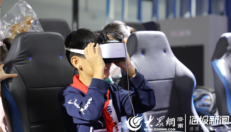 06精敏数字展厅内，一名儿童在体验并感受VR模拟驾驶.JPG
